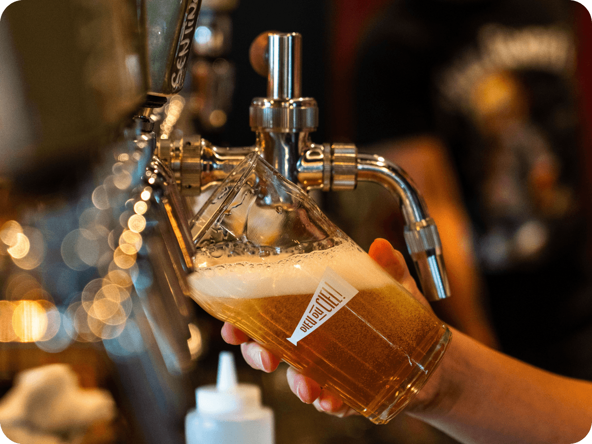 A bartender beside a rotating tap list powered by a live Untappd menu.