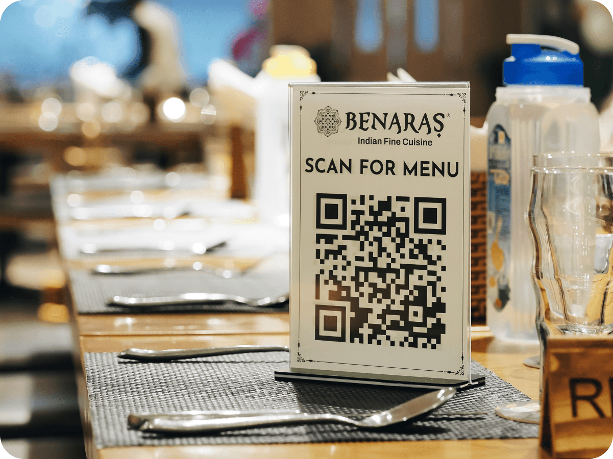 A diner scanning a branded QR table tent, today’s menu on their phone.